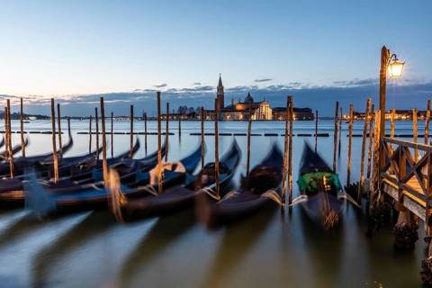 Morning atmosphere in front of sunrise, gondolas, San Giorgio Maggiore church in the background,