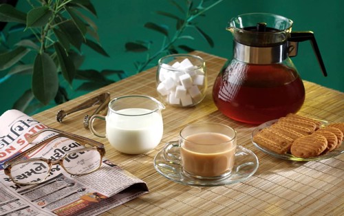 Tea time with biscuits and news paper, India, Asia