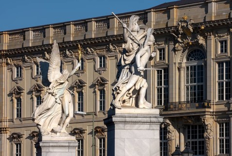 Berlin, Humboldt Forum in the Berlin Palace, in front of figures on the Palace Bridge