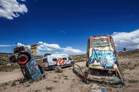 Motorhome and scrap cars decorated with graffiti in the Carforest of Goldfield, Nevada, USA, North