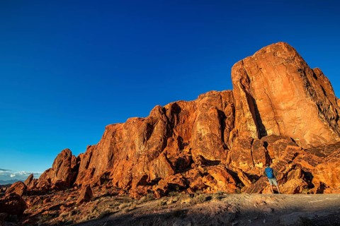 Hiker in front of Gibraltar Rock, Valley of Fire State Park, Nevada, USA, North America