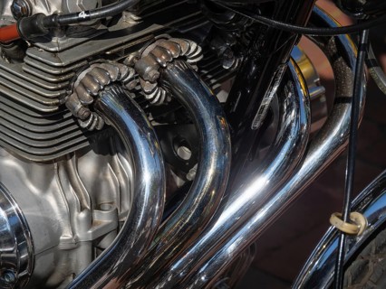 Detailed view of shiny chrome-plated motorbike exhaust pipes and engine parts, Appelhülsen,