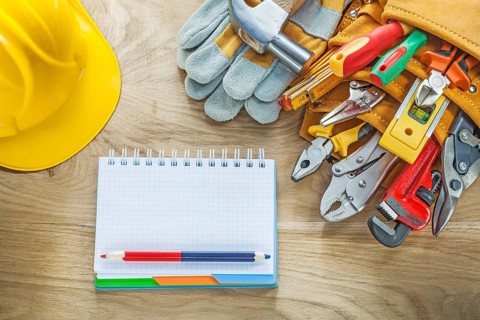 Construction tooling tool belt safety gloves claw hammer notepad pencil hard hat