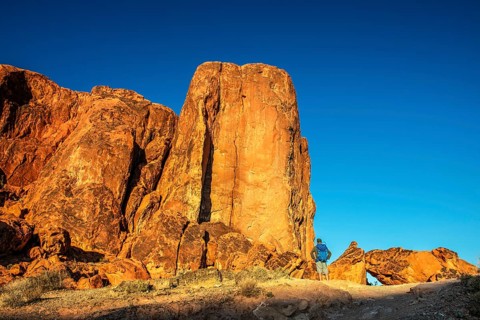 Hiker in front of Gibraltar Rock, Valley of Fire State Park, Nevada, USA, North America