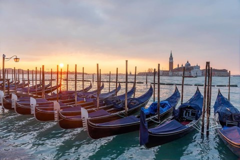 Cloudy atmosphere at sunrise, gondolas, San Giorgio Maggiore church in the background, Venice,