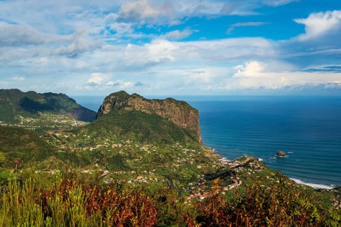 View of the Penha d'Águia (Eagle Rock) and the surrounding coastal landscape with lush greenery and