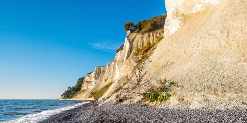 Pebble beach with flints on the chalk cliffs of Møns Klint on the Baltic Sea, Møn Island, Denmark,