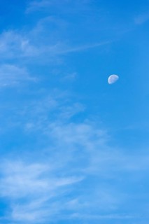 Light clouds in blue sky, waning moon, blurred, full-frame, East Sussex, South Downs, England,