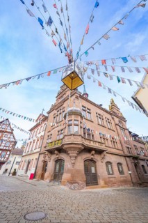 Historic building with colourful pennants on a cobblestone square, Meßkirch, Sigmaringen district,