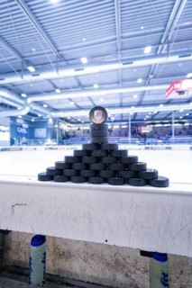Pyramid-shaped stacked ice hockey pucks in a large ice rink, Heilbronner Falken Vs Bietigheimer