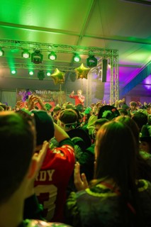 Energetic concert scene with a dense crowd and green-lit stage, carnival, Schlagerkuchen Donzdorf,