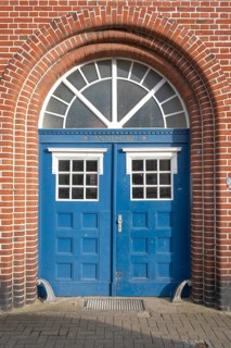 View of an entrance area of an old town house, street photography, double wing door, entrance door,