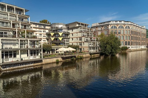 Elster Lofts residential building and the Weiße Elster river in Leipzig, Saxony, Germany, Europe