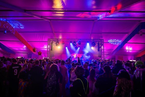 Large crowd enjoying a concert in a festively lit tent, carnival, Schlagerkuchen Donzdorf,