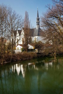 The Church of the Brethren is reflected in the River Lippe in spring in Lippstadt, North