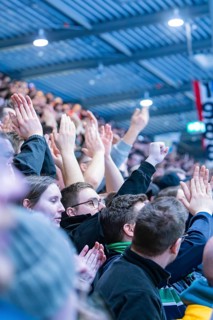 Cheering spectators in the stadium clap and raise their hands, Heilbronner Falken Vs Bietigheimer