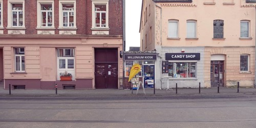 View of a house facade with a small kiosk between two houses, old, historical, entrance door, city,