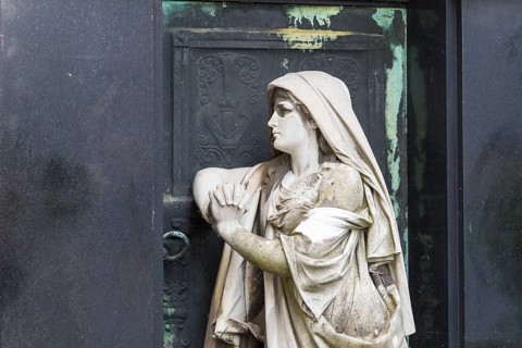 Figure of a praying woman at a historic grave, cemetery of the Emmaus Church in Kaditz, Dresden,