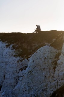 Walkers enjoying views of cliffs, chalk coast, backlight, Beachy Head, Eastbourne, South Downs,