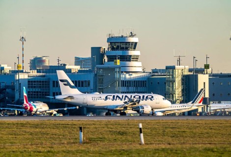 Finnair aircraft on the taxiway, apron of Düsseldorf International Airport, old air traffic control