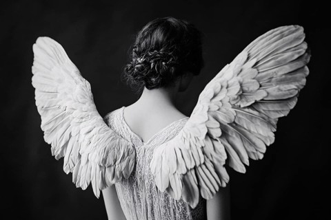 Black and white image of young female angel with white feather wings on back. Generative AI, AI