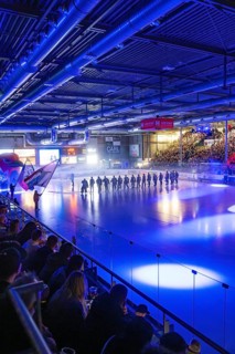 Ice hockey match in the stadium with illuminated ice surface and full crowd, Heilbronner Falken Vs