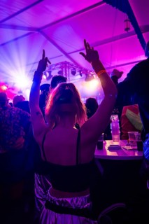 A woman dances at a lively party under colourful lighting, carnival, hit cake Donzdorf, district of
