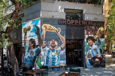 Lionel Messi with World Cup trophy on the wall of a house at El Caminito, La Boca, Buenos Aires,