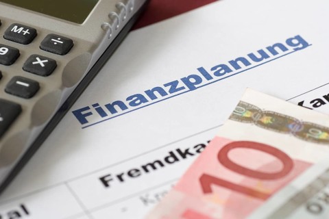 Financial planning of a self-employed person, pocket calculator, euro banknote, 10 euro note