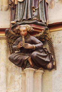 Choir hall, angel with flute as a console under the figure of Charlemagne on the eastern end wall
