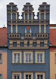Renaissance ornamentation on a town house with town coat of arms consisting of three anchors