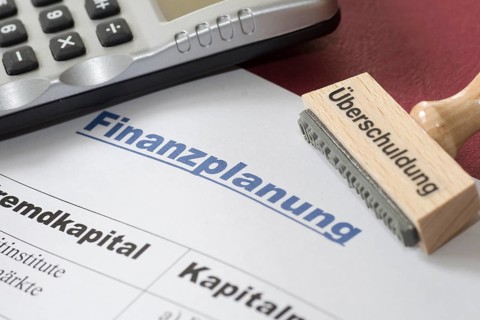 Financial planning of a self-employed person, stamp over-indebtedness, pocket calculator, borrowed