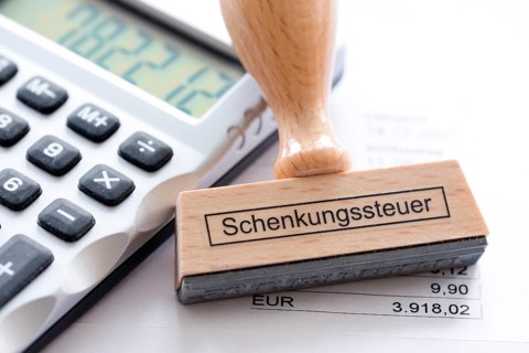 Stamp with the inscription gift tax, office, desk, calculator, processing, tax, tax office