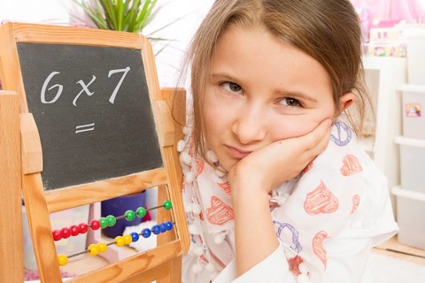 Frustration at school, arithmetic, lack of concentration, 7 year old girl looks unhappy and