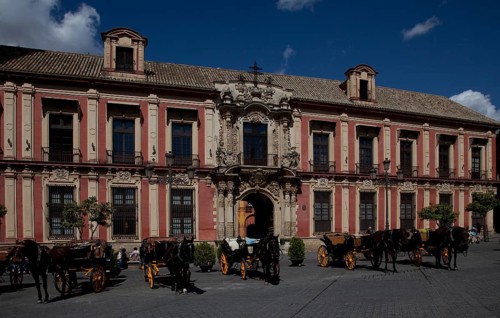 Seville, Archbishop's Palace. South façade detail with portal in front Horse-drawn carriages, St,