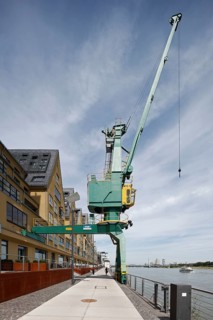Historic Siebengebirge warehouse, converted into modern residential buildings, waterside with crane
