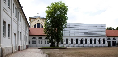 Concert hall in former riding arena, castle church behind it
