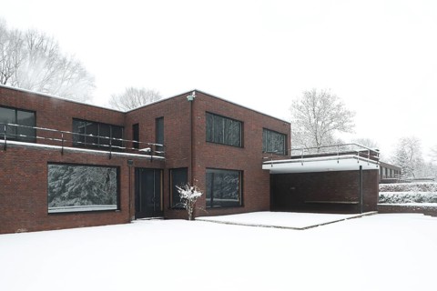 Built between 1928 and 1930 by Ludwig Mies van der Rohe as a residential building, garden side