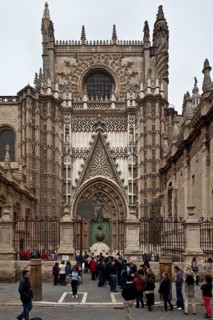 Seville, Cathedral. South portal in front of it Original of the bronze sculpture crowning the bell