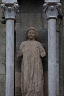 Sculpture of a youth in the central buttress canopy on the north side of the three western nave