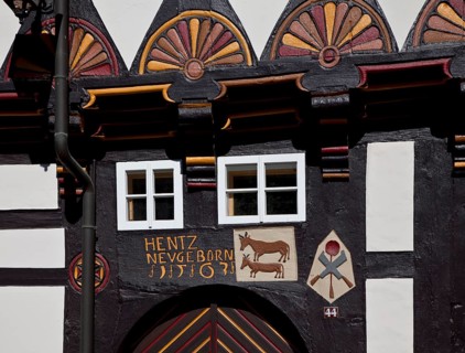 Former cookshop 1563, portal detail with relief symbols of cattle, cooking spoon and knife