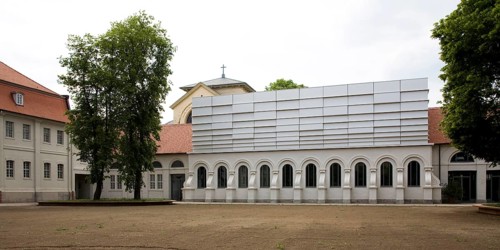 Concert hall in former riding arena, castle church behind it