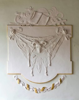 Hall on the upper floor, supraporte with ram skin made of white stucco