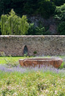 Monastery wall and fountain bowl in the former cloister