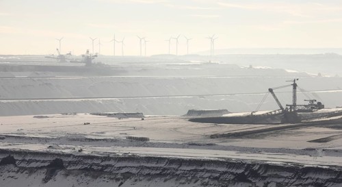 Landscape in the snow, wind turbines in the background