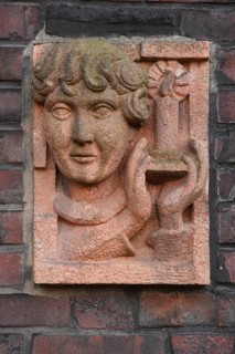 1926-1927 Architect: Figge, relief at a house entrance, head and candle, sculptor: Dorn