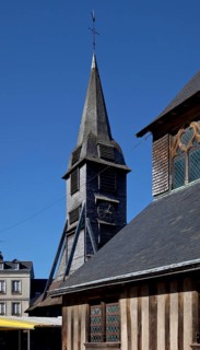Free-standing tower from the end of the 15th century covered with chestnut wood shingles, nave on