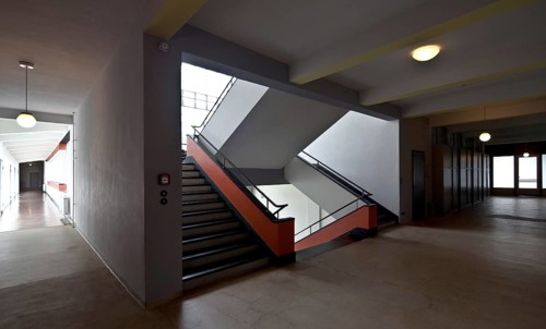 First floor, view of the staircase and corridor of the former vocational school, bridge on the left