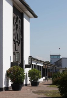 Butzweilerhof, reception building from 1936 with eagle, tower in the background