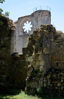 Ruins of the monastery church from the north, behind the ruins of the south transept with rose